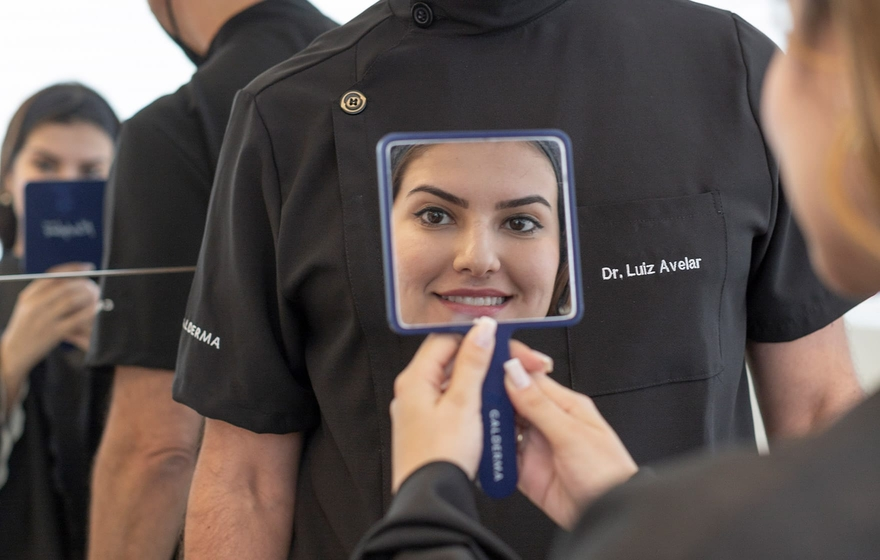 Fillers, smiling woman holding a mirror